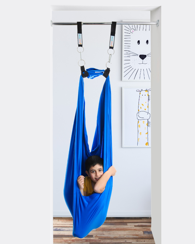 a boy is relaxing in a doorway sensory swing