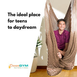 A teen boy is using a hammock swing, which is an ideal place for teens to daydream.