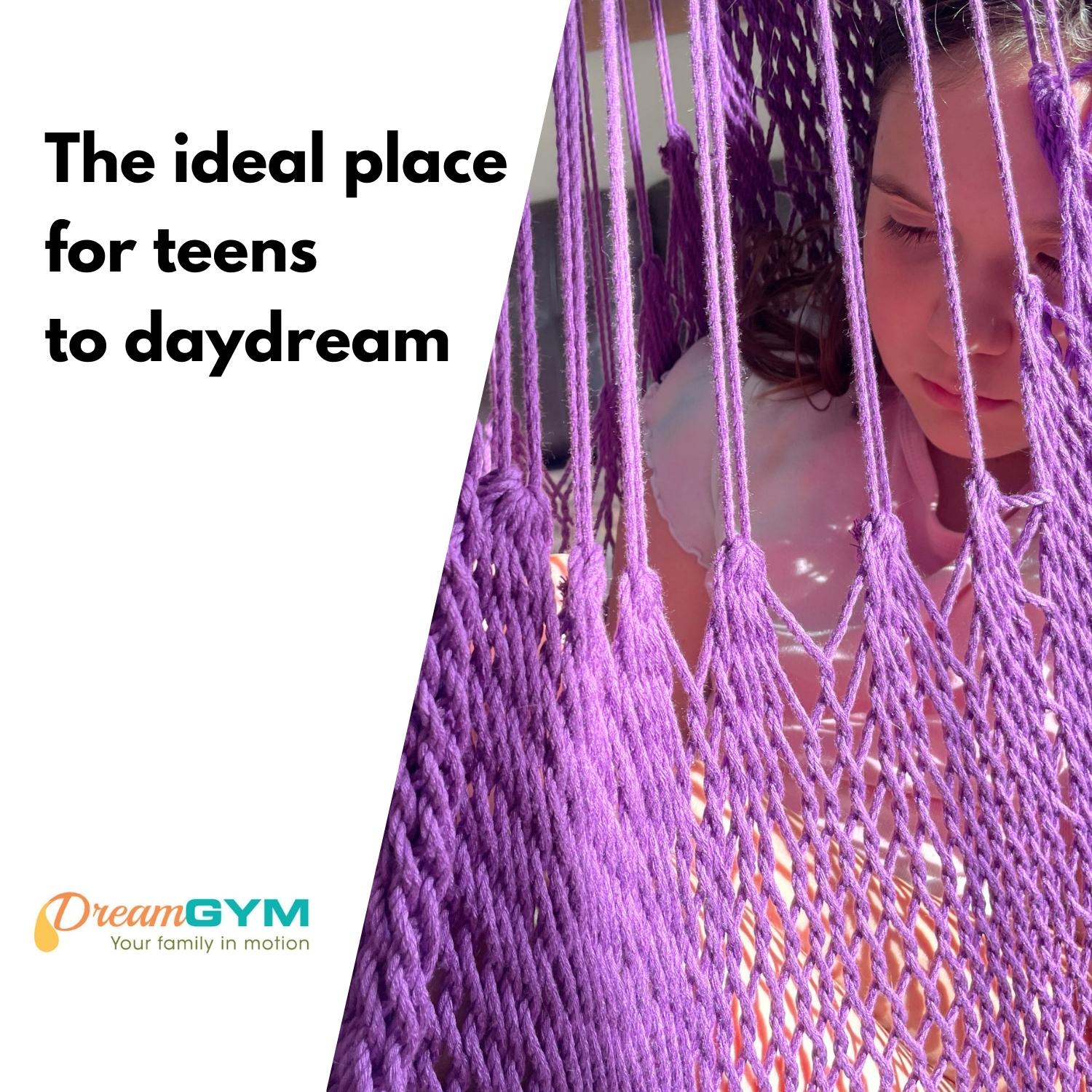 A girl is resting in a hammock swing. THe ideal place for teens to daydream.