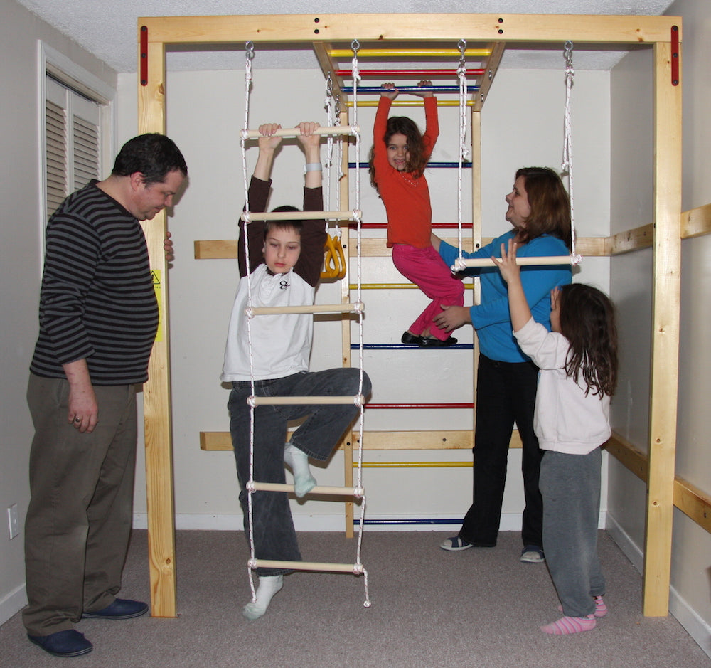 Indoor jungle gym custom built by DreamGYM Inc. in the basement, there is a family of 5: mom, dad, a boy and two girls.