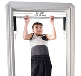DreamGYM Doorway Swing Support bar requires 26-36" wide door frame. A teen boy is doing pull-ups on the bar. 