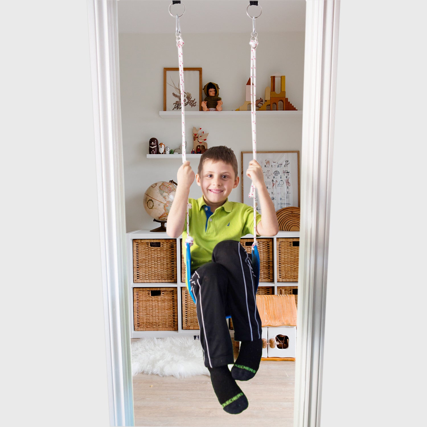 A boy is using a doorway swing
