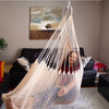 A woman is enjoying a Therapy Hammock Swing in a living room- Soft Ivory - DreamGYM