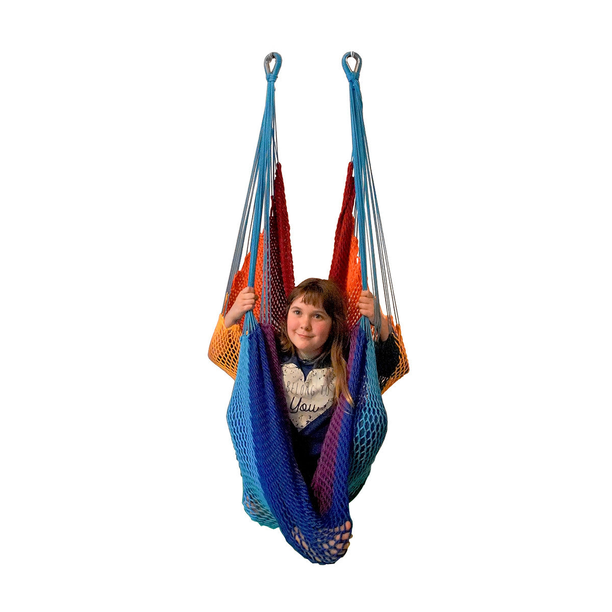 A girl is sitting in a Therapy Net Swing - Rainbow - DreamGYM