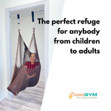 An adult is using a brown hammock swing installed in a doorway. The perfect refuge for anybody from children to adults.