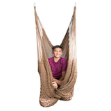 A teen boy is sitting in a brown hammock swing