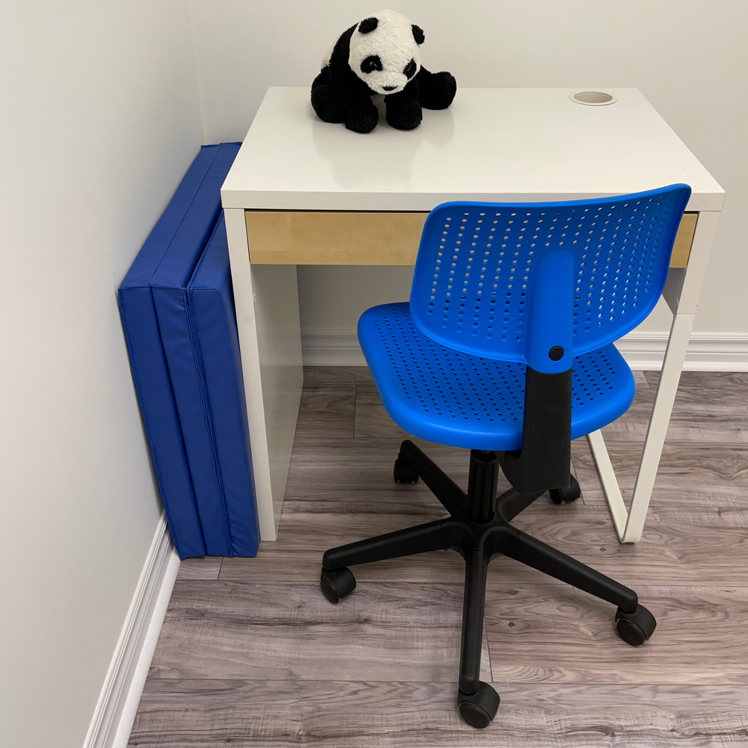 Tri-folded Exercise mat stored behind the desk